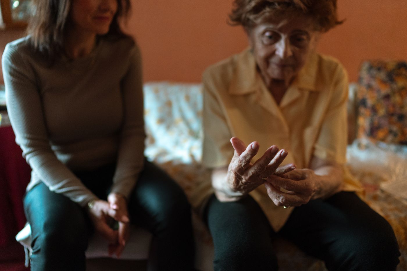 A caregiver sharing a warm moment with an older adult at home